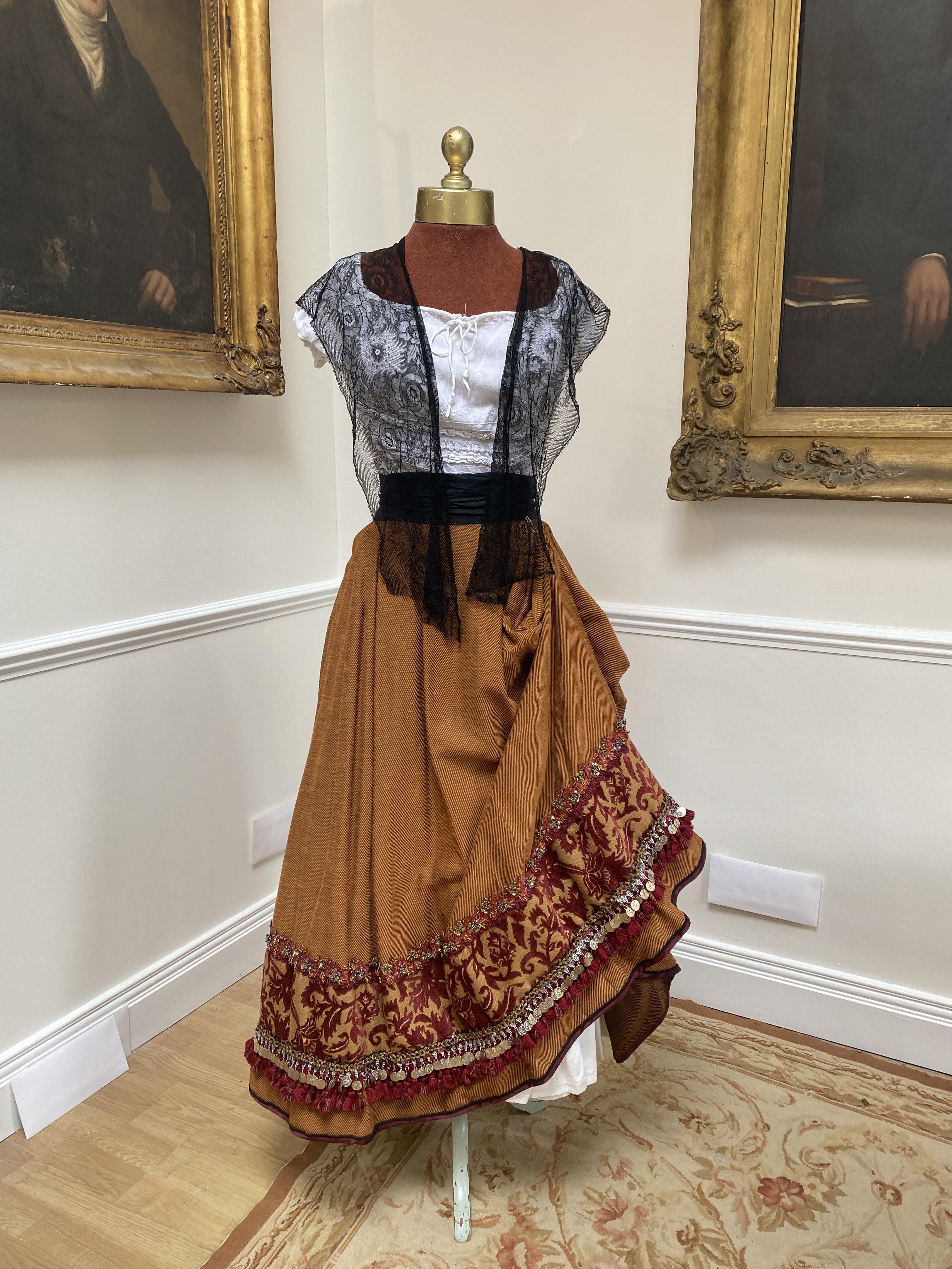 Carmen costume. A heavy embroidered skirt, and white cotton blouse, silk black waist sash and black lace shawl. Size 10 to 16